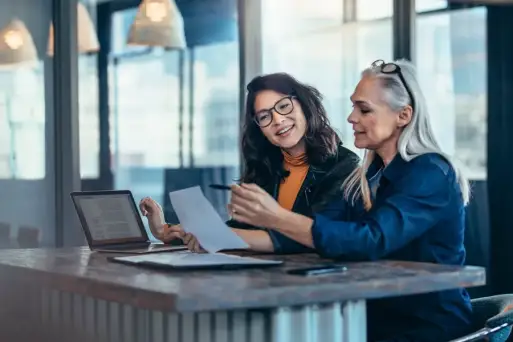 two colleagues looking at a business report